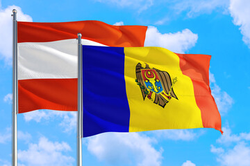 Moldova and Austria national flag waving in the windy deep blue sky. Diplomacy and international relations concept.