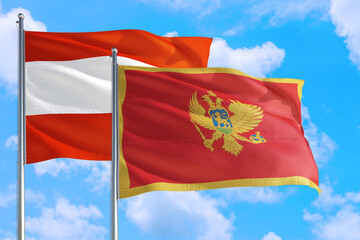 Montenegro and Austria national flag waving in the windy deep blue sky. Diplomacy and international relations concept.