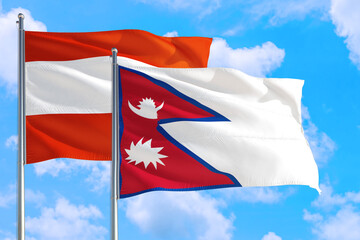 Nepal and Austria national flag waving in the windy deep blue sky. Diplomacy and international relations concept.
