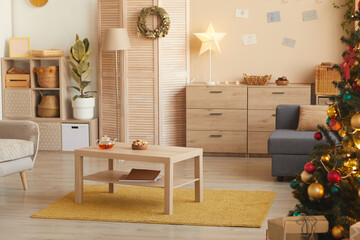 Warm-toned background image of cozy living room interior with Christmas tree decorated with golden details, copy space