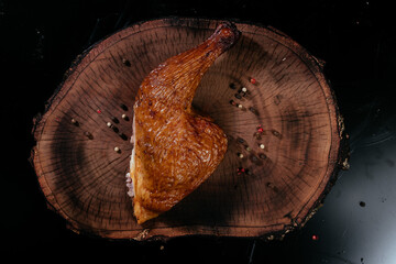 Smoked Chicken thigh fragrant juicy, on a wooden board. Top view.