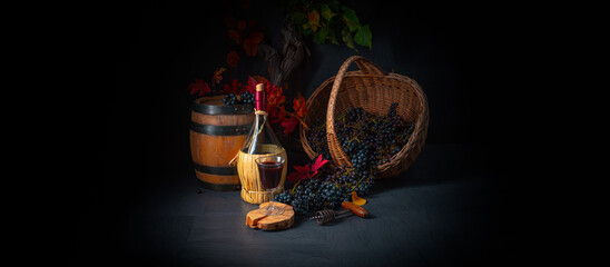 Grapes in the basket with wine and tree leaves
