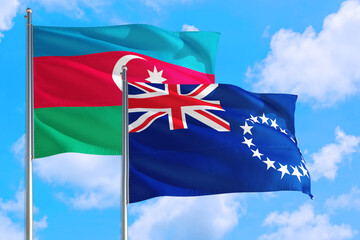 Cook Islands and Azerbaijan national flag waving in the windy deep blue sky. Diplomacy and international relations concept.