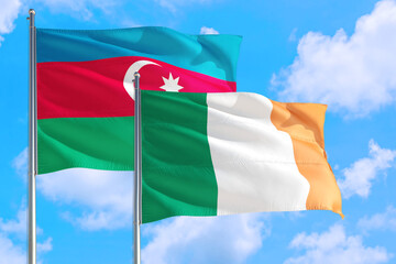 Ireland and Azerbaijan national flag waving in the windy deep blue sky. Diplomacy and international relations concept.