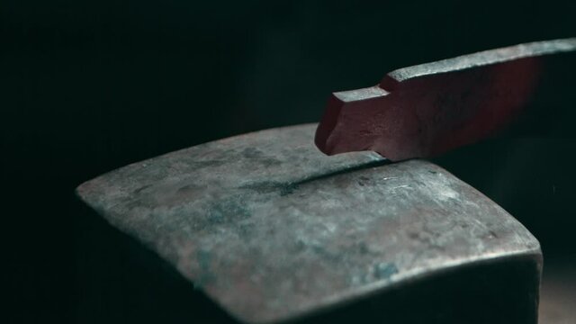 Metal piece hammered on a square anvil