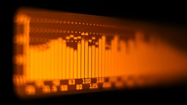 The professional concert equalizer has a yellow spectrum analyzer on the display that analyzes the frequency range of music or any sound and can change it. Closeup