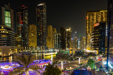 Fototapeta premium Dubai Marina at night, with all the lights from buildings and the boats making for a beautiful scene