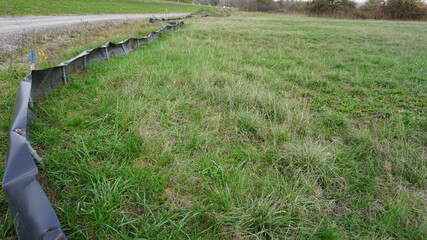 Obraz premium safety fence for frogs in the community Au am Rhein in the region Baden-Wuerttemberg with the view of the community Lauterbourg in France in the month of November, Germany 