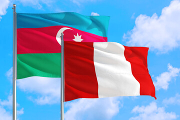 Peru and Azerbaijan national flag waving in the windy deep blue sky. Diplomacy and international relations concept.