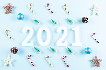 Top view of wooden numbers 2021 on pastel blue background. New year or Christmas concept.
