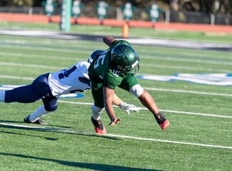 Football player making a tackle during a game