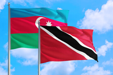 Trinidad And Tobago and Azerbaijan national flag waving in the windy deep blue sky. Diplomacy and international relations concept.