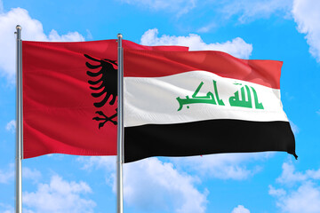 Iraq and Albania national flag waving in the windy deep blue sky. Diplomacy and international relations concept.