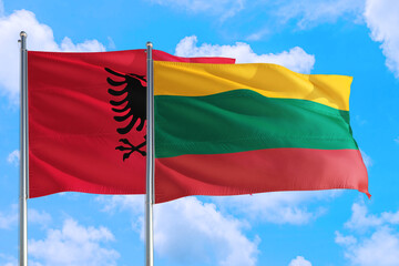 Lithuania and Albania national flag waving in the windy deep blue sky. Diplomacy and international relations concept.
