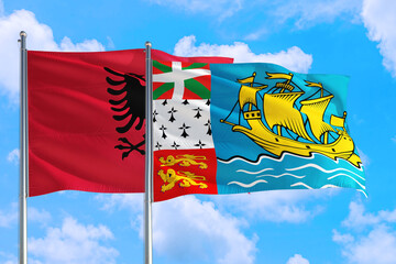 Saint Pierre And Miquelon and Albania national flag waving in the windy deep blue sky. Diplomacy and international relations concept.