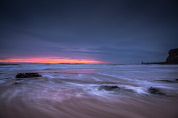 A beautiful sunrise at Tynemouth's King Edward's Bay, with sunlight appearing on the horizon