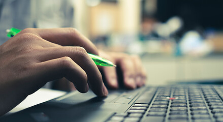 Fototapeta premium close up of business people pressing keyboard of notebook, working online and business online