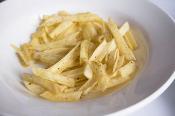 white plate with potato chips, close up