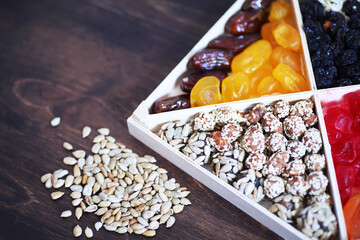 Nuts and dried fruits assortment on stone table top view.