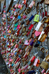 locks on a lattice on a bridge. Each was attached as a sign of a couple's love