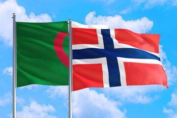 Bouvet Islands and Algeria national flag waving in the windy deep blue sky. Diplomacy and international relations concept.