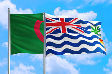 British Indian Ocean Territory and Algeria national flag waving in the windy deep blue sky. Diplomacy and international relations concept.