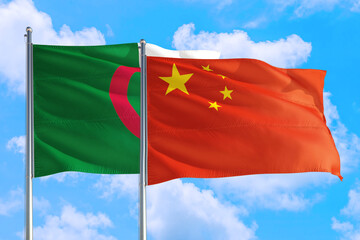 China and Algeria national flag waving in the windy deep blue sky. Diplomacy and international relations concept.