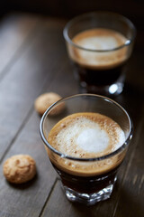 Two Glasses Of Coffee with Milk on dark wooden background.	