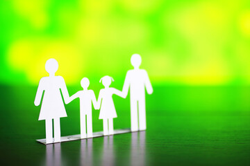 Cutout paper chain family with the protection of cupped hands, concept for security and care