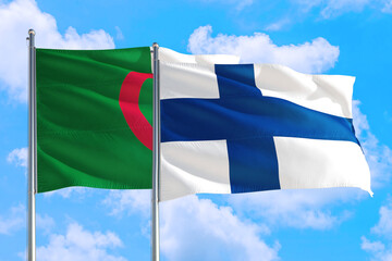 Finland and Algeria national flag waving in the windy deep blue sky. Diplomacy and international relations concept.