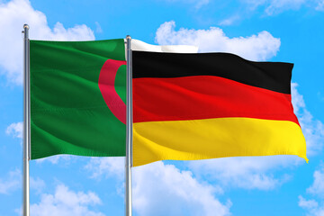 Germany and Algeria national flag waving in the windy deep blue sky. Diplomacy and international relations concept.
