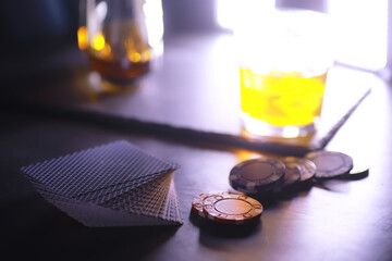 Gambling Card games for money. Texas Hold'em Poker. Cards in hand, playing chips, deck of cards of alcohol in a glass.