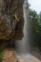 Berchtesgaden waterfall under the cliffs on a summer day at lake K&ouml;nigssee