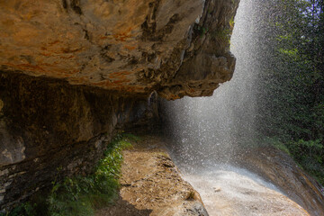 Berchtesgaden waterfall under the cliffs on a summer day at lake K&ouml;nigssee