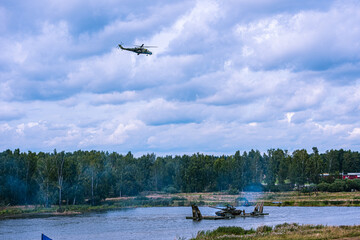 An army helicopter flying over a training battlefield