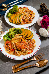 Delicious tomato spaghetti on the table (Served with cauliflower, pumpkin, shiitake mushrooms)