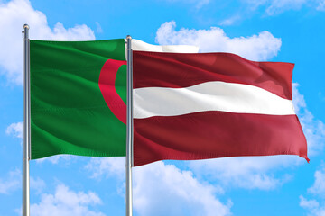 Fototapeta na wymiar Latvia and Algeria national flag waving in the windy deep blue sky. Diplomacy and international relations concept.