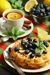 Belgian waffles with blueberry and a cup of tea with lemon