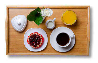 Wooden tray with breakfast cup of coffee and cake on white background isolation, top view