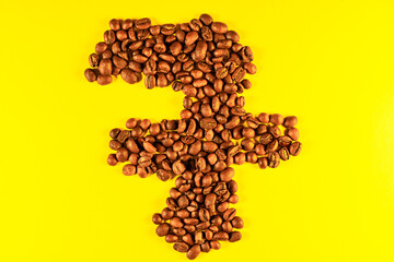 Numbers made with coffee grains on a yellow background.