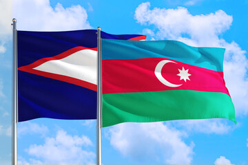 Azerbaijan and American Samoa national flag waving in the windy deep blue sky. Diplomacy and international relations concept.