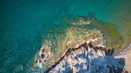 Aerial top view of sea waves break on a beach. drone shot Greece