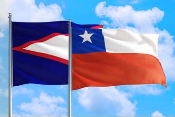 Chile and American Samoa national flag waving in the windy deep blue sky. Diplomacy and international relations concept.