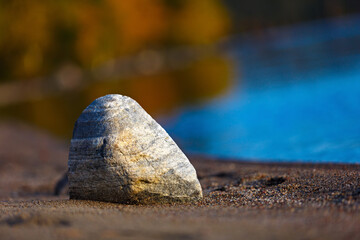 Stone on a sandy beach by the sea.