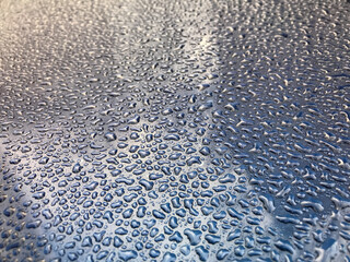 Water drops on the roof of the car. Weather changes
