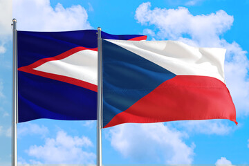 Czech Republic and American Samoa national flag waving in the windy deep blue sky. Diplomacy and international relations concept.