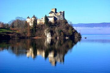 Medieval castle in Niedzica by Czorsztyn lake in autumn sunny day, Pieniny, Poland