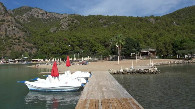 Oludeniz beach, Fethiye, Turkey - 24th of October 2020: 4K Water bicycles and few people on the Blue lagoon beach

