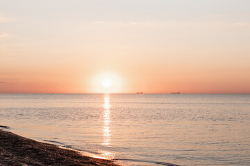 view of sunrise above the sandy sea beach