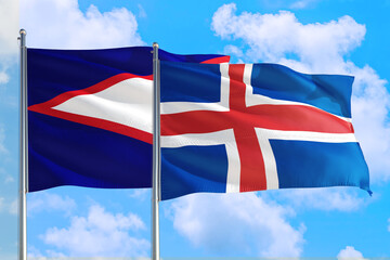 Iceland and American Samoa national flag waving in the windy deep blue sky. Diplomacy and international relations concept.